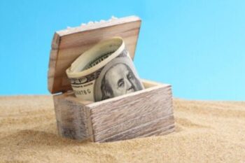 Chest with money on a beach